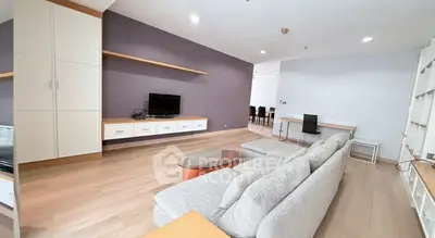 Spacious modern living room with sleek furniture and open layout, perfect for relaxation and entertainment.