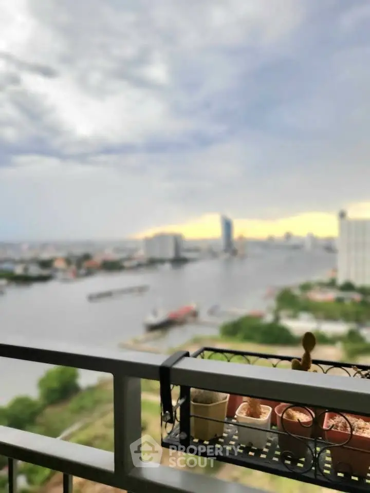 Stunning river view from high-rise balcony with city skyline backdrop.