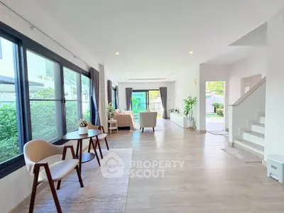 Spacious modern living room with large windows and stylish furniture