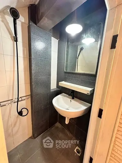 Compact modern bathroom with sleek fixtures and stylish tile design.