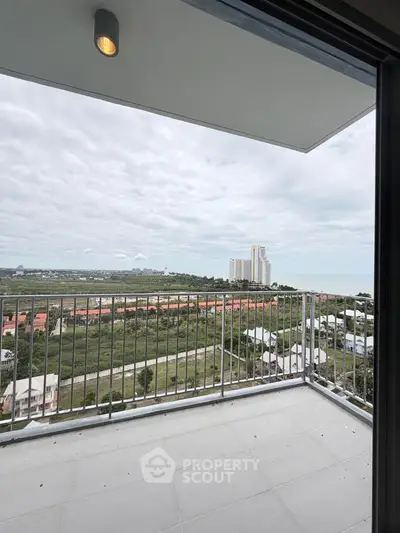 Stunning balcony view with expansive cityscape and ocean horizon, perfect for relaxation and enjoying sunsets.