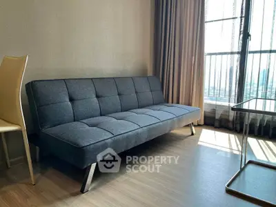 Modern living room with stylish sofa and large window offering natural light