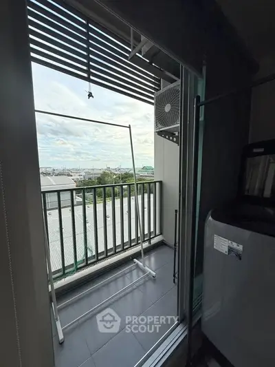 Charming balcony with laundry area and scenic view, perfect for urban living.