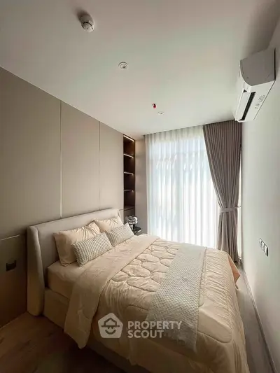 Modern bedroom with elegant decor and natural light, featuring a cozy bed and stylish curtains.