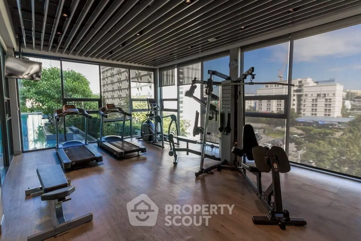 Modern gym with state-of-the-art equipment and panoramic city views.