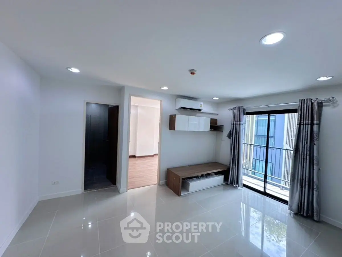 Modern living room with sleek design and large window for natural light