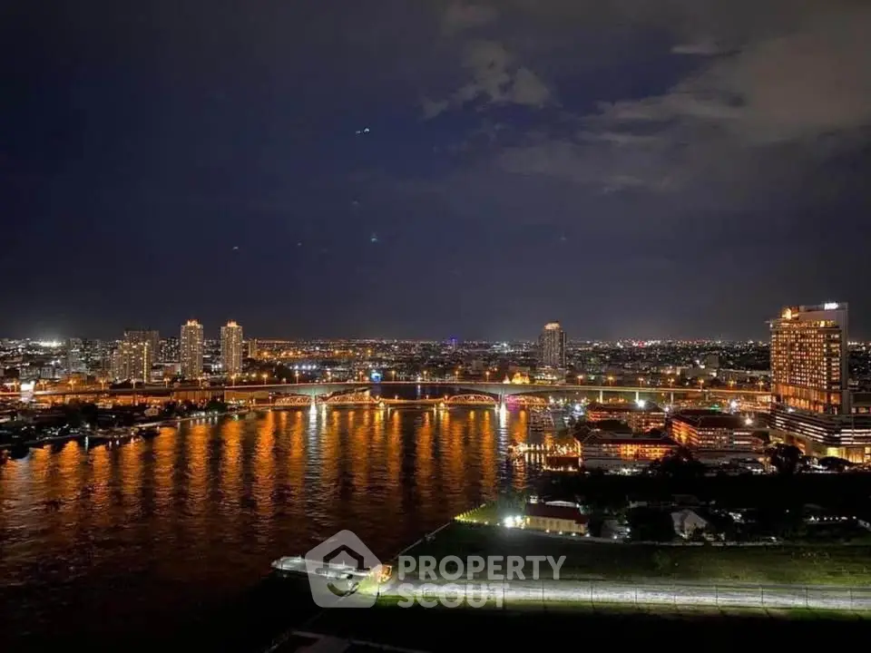 Stunning night view of city skyline with illuminated river and bridges, perfect for urban living enthusiasts.