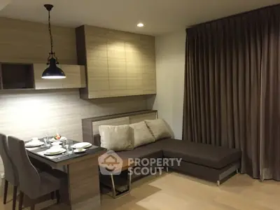 Modern living room with cozy sectional sofa and dining area in stylish apartment.