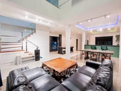 Spacious modern living room with open kitchen and stylish staircase