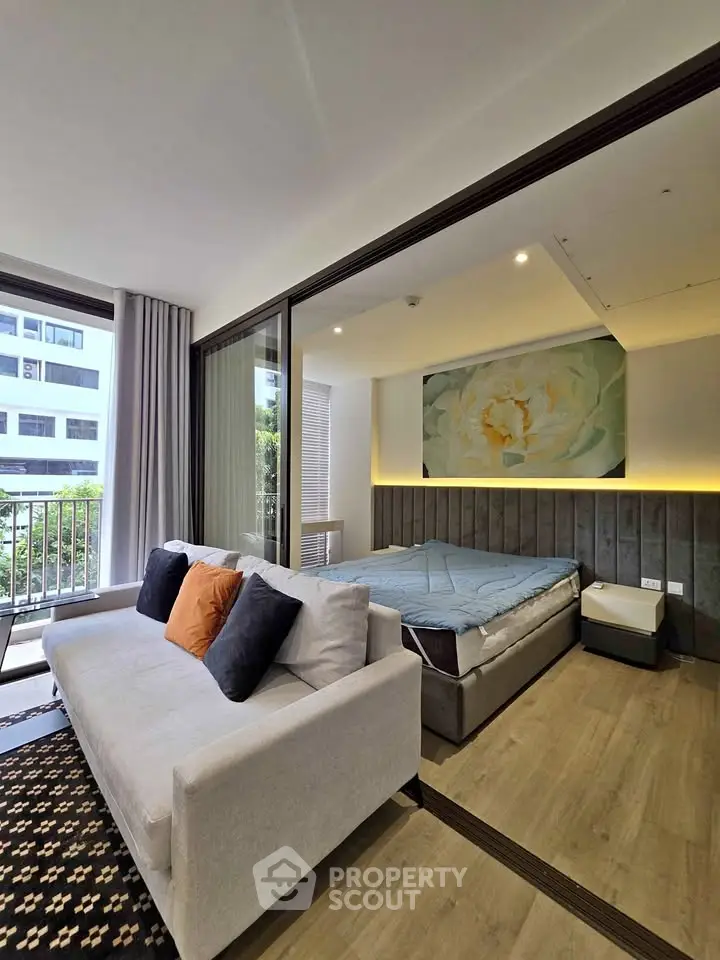 Modern studio apartment with cozy living area and balcony view