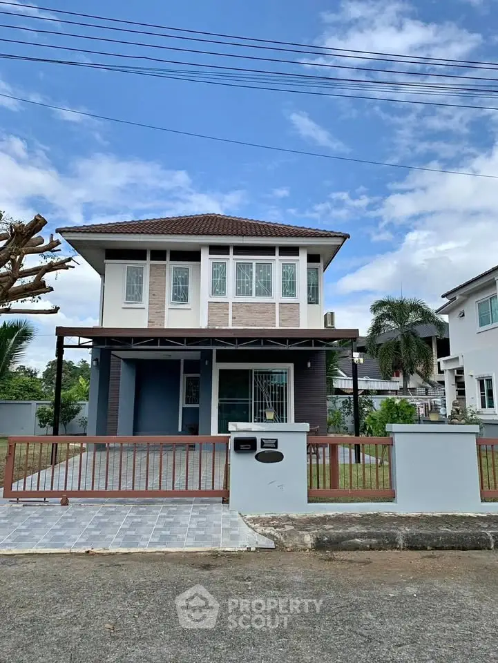 Charming two-story house with modern design and spacious front yard in a serene neighborhood.