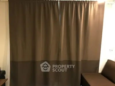 Cozy interior with brown curtains and sofa, perfect for a relaxing living space.