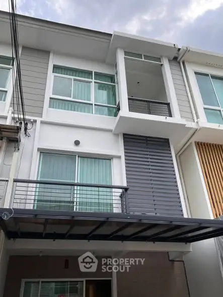 Modern townhouse exterior with sleek design and large windows