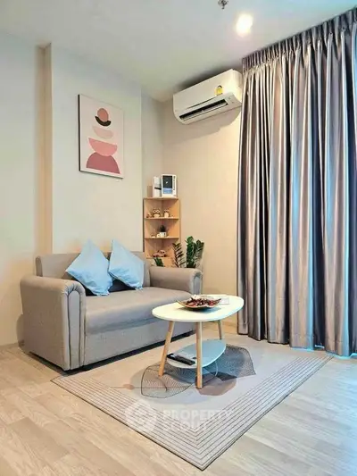 Modern living room with cozy sofa, stylish decor, and air conditioning in a bright apartment.