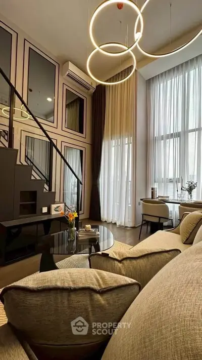 Luxurious modern living room with high ceilings and elegant lighting in a stylish apartment.