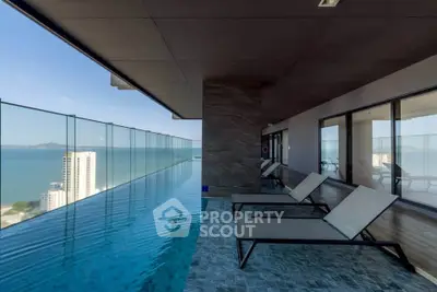Luxurious rooftop infinity pool with stunning ocean view and modern lounge chairs.