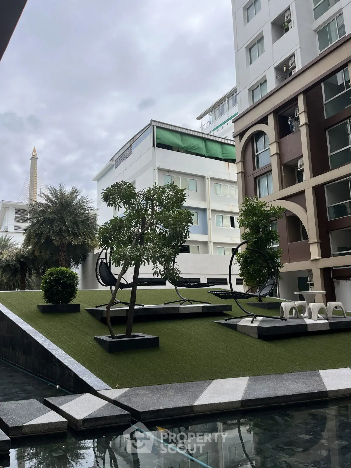 Modern apartment building with landscaped garden and seating area