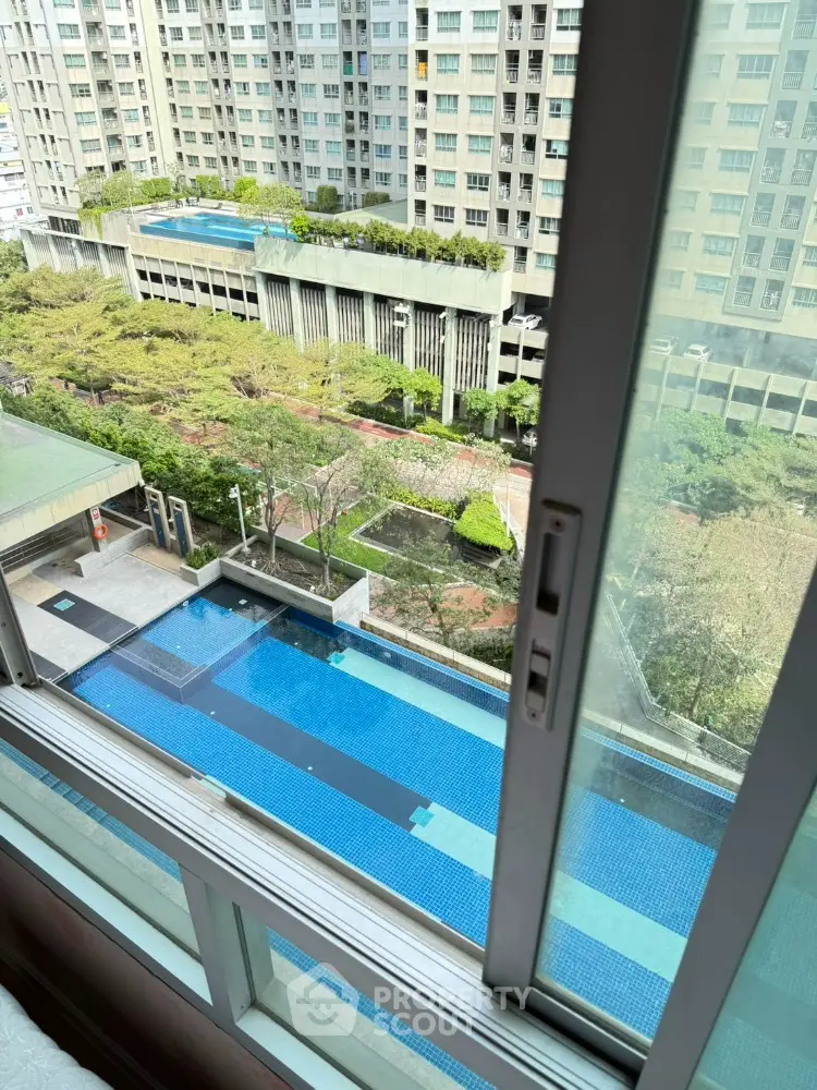 Stunning high-rise apartment view with pool and lush gardens