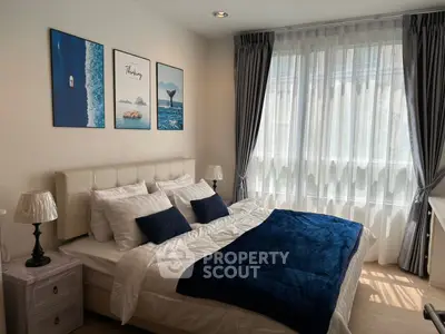 Elegant bedroom with plush bedding and natural light, perfect for relaxation.