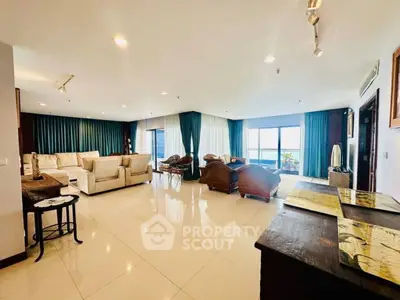 Spacious living room with elegant furniture and large windows offering stunning views.