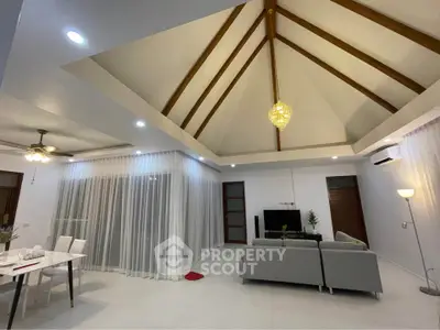 Spacious living room with high ceiling and modern decor