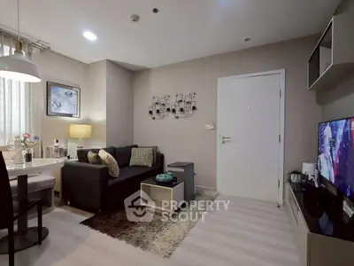 Modern living room with cozy sofa, stylish decor, and flat-screen TV in a contemporary apartment.