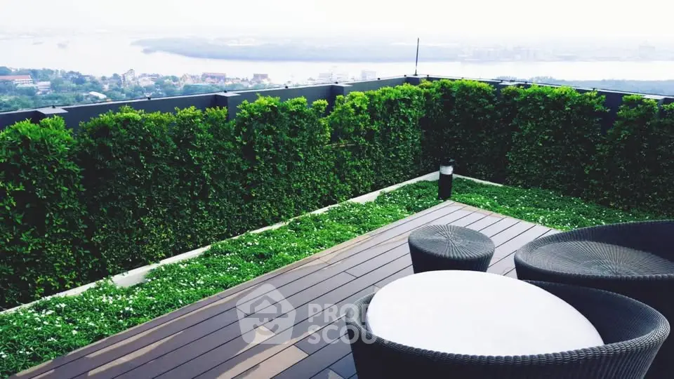Stunning rooftop garden with panoramic city and river views, featuring stylish outdoor seating.