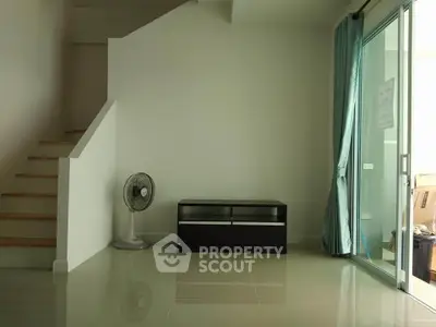 Minimalist interior with staircase and sliding glass door in modern home