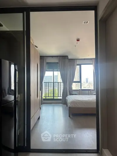 Modern bedroom with balcony view in high-rise apartment