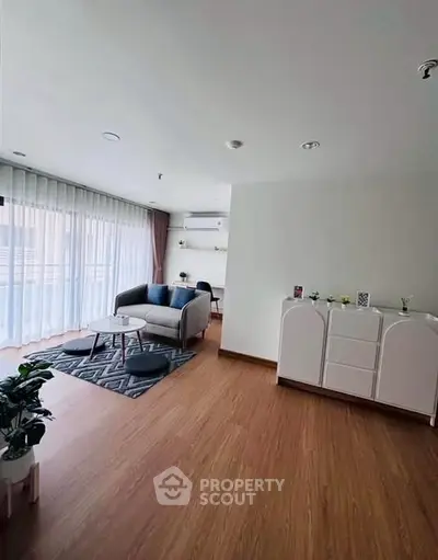 Spacious living room with modern decor and large windows for natural light.