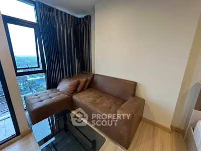 Cozy living room with brown sectional sofa and city view from large window.