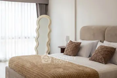 Elegant bedroom with plush bedding and unique wavy mirror design