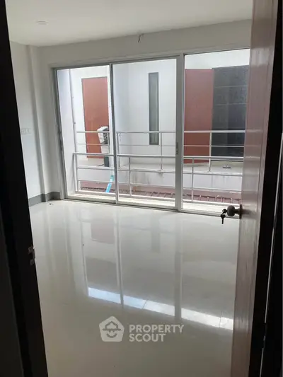 Spacious room with large sliding glass doors leading to a balcony, perfect for natural light.