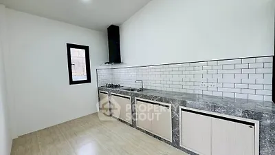 Modern kitchen with sleek countertops and gas stove in minimalist design