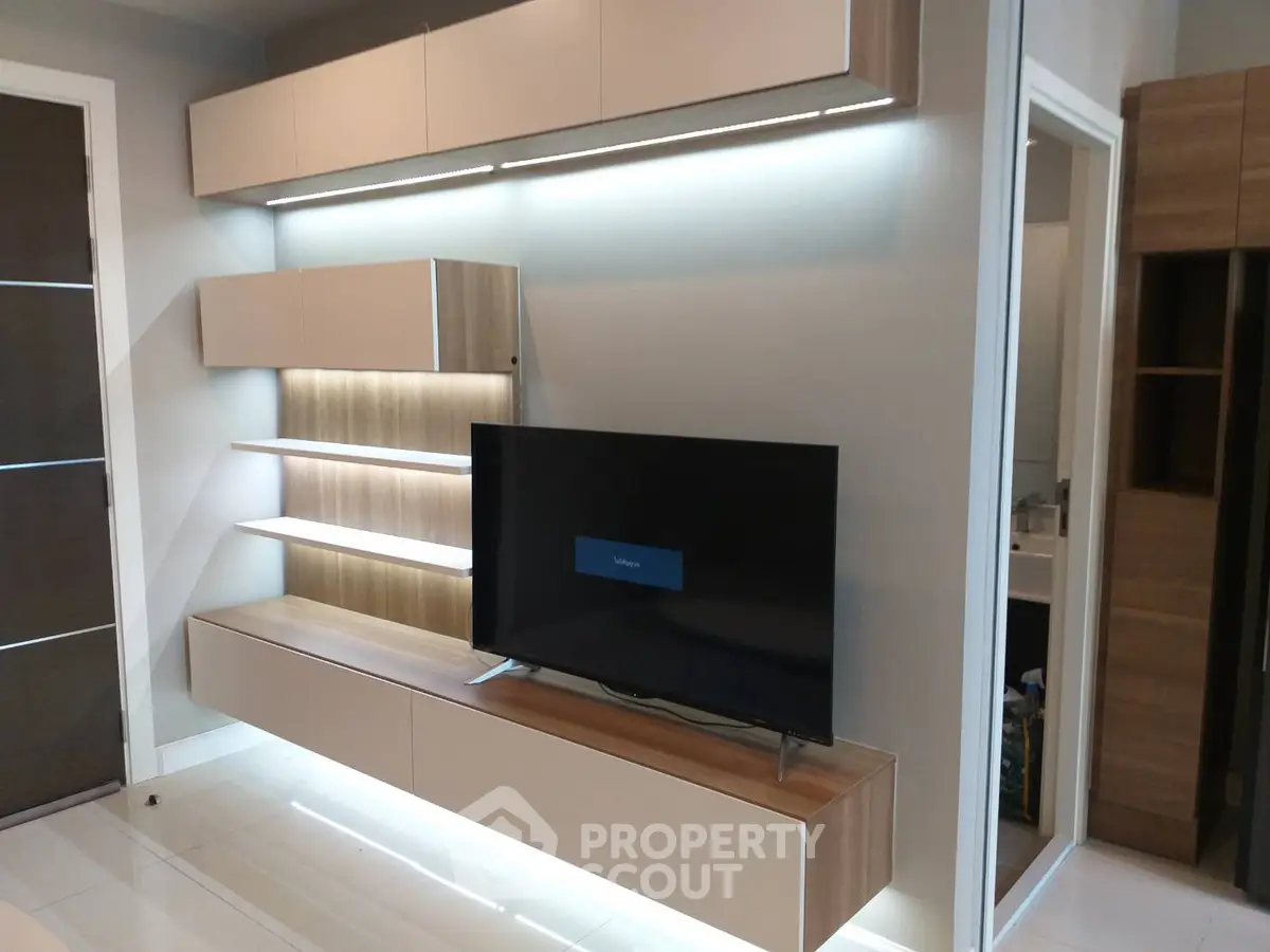 Modern living room with sleek TV unit and ambient lighting