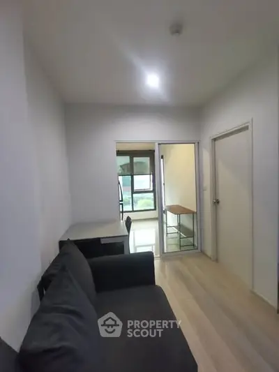 Modern apartment interior with cozy living area and study nook