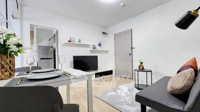 Modern living room with stylish decor and dining area in a cozy apartment.