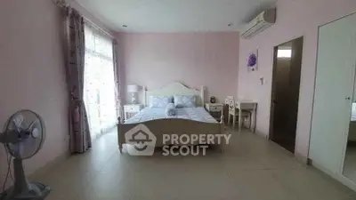 Spacious bedroom with elegant decor and natural light