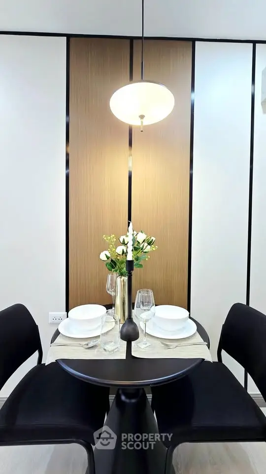 Modern dining area with elegant table setting and contemporary lighting