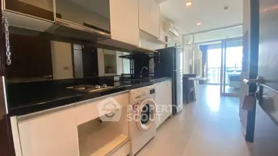 Modern kitchen with sleek appliances and open layout in a bright apartment.