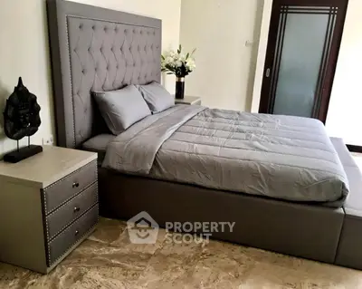 Luxurious bedroom with elegant gray bed and stylish decor