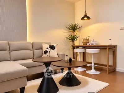 Stylish modern living room with cozy sofa, chic coffee tables, and elegant lighting.