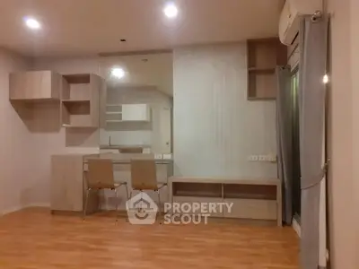 Modern living room with wooden flooring and stylish furniture in a cozy apartment.