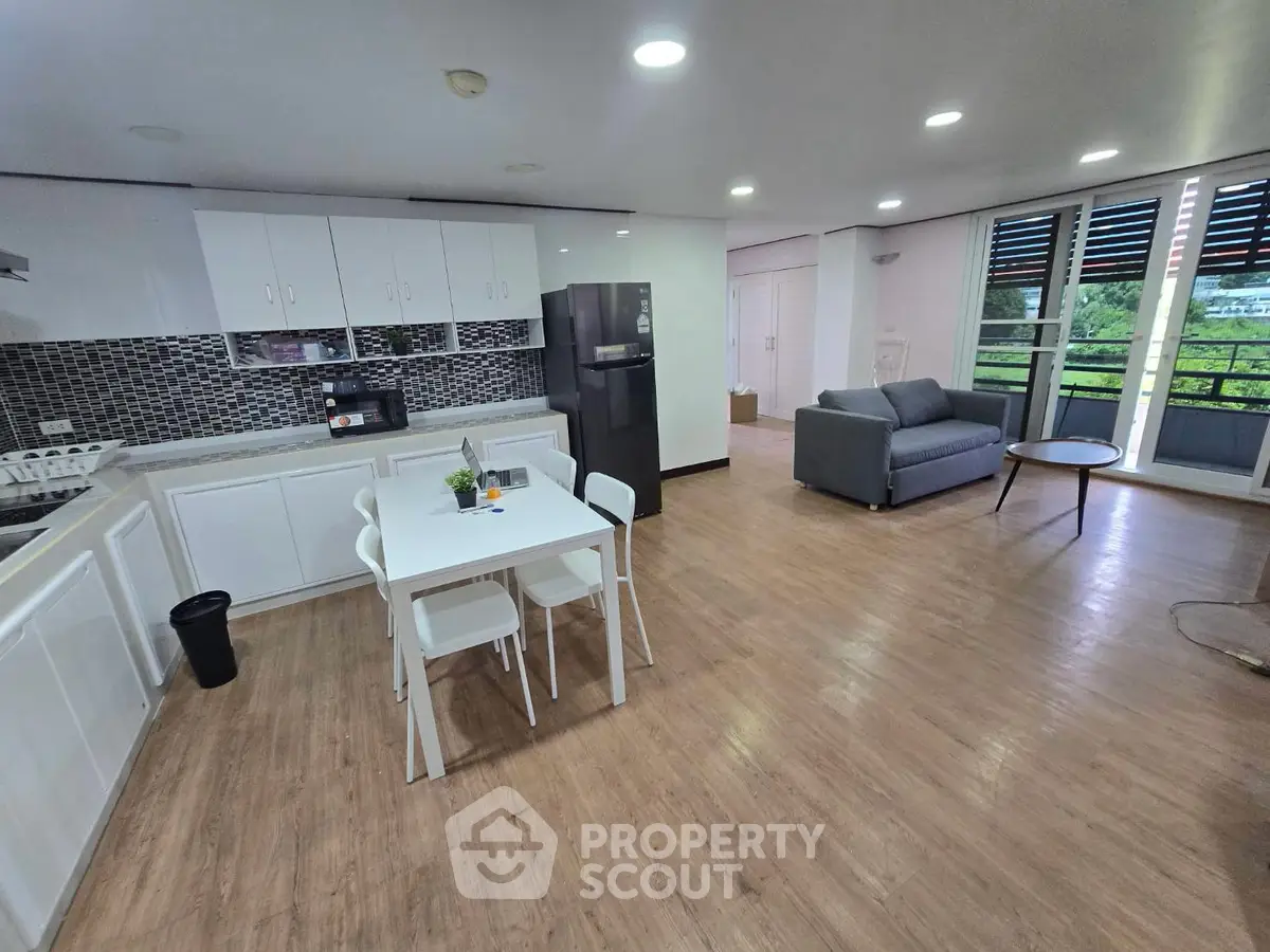 Spacious open-layout kitchen and living room with modern appliances and stylish decor