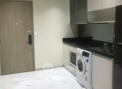 Modern kitchen with sleek appliances and marble flooring