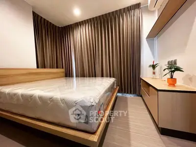 Modern bedroom with sleek design, featuring a large bed and stylish curtains, perfect for relaxation.