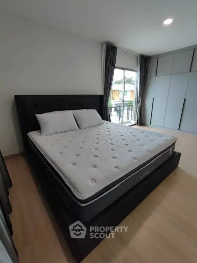 Spacious bedroom with modern design and large window view