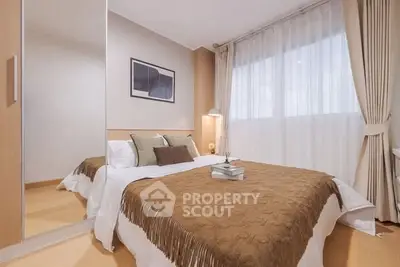 Cozy bedroom with elegant decor and large window for natural light