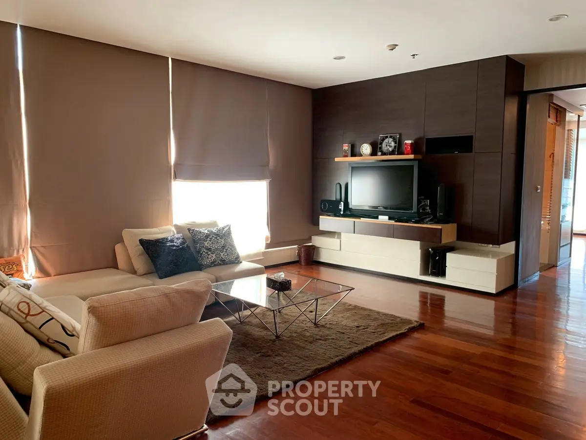 Luxurious living room with modern decor and hardwood floors in upscale apartment.