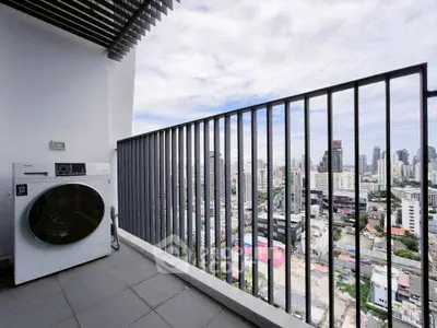 Modern balcony with city view and washing machine, perfect for urban living.